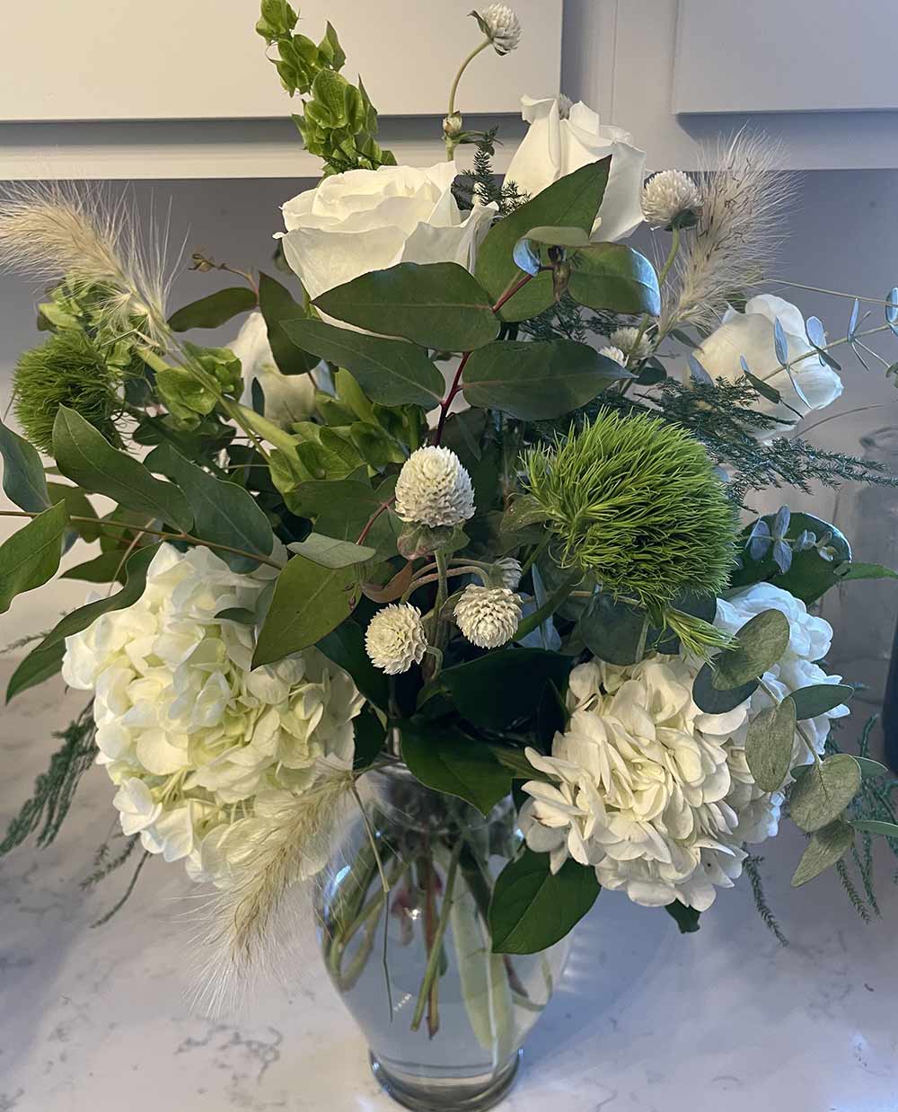 Tall Vase Flower Arrangement with white roses by Blooms and Wishes, a florist in Columbia, MO