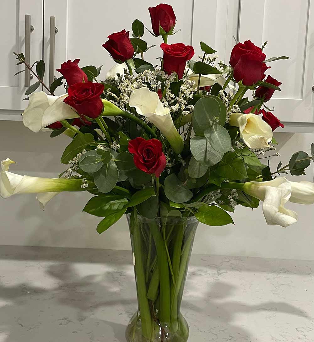 Rose flower arrangement in vase (red and white roses in a glass vase) by Blooms and Wishes, a florist located in Columbia, MO